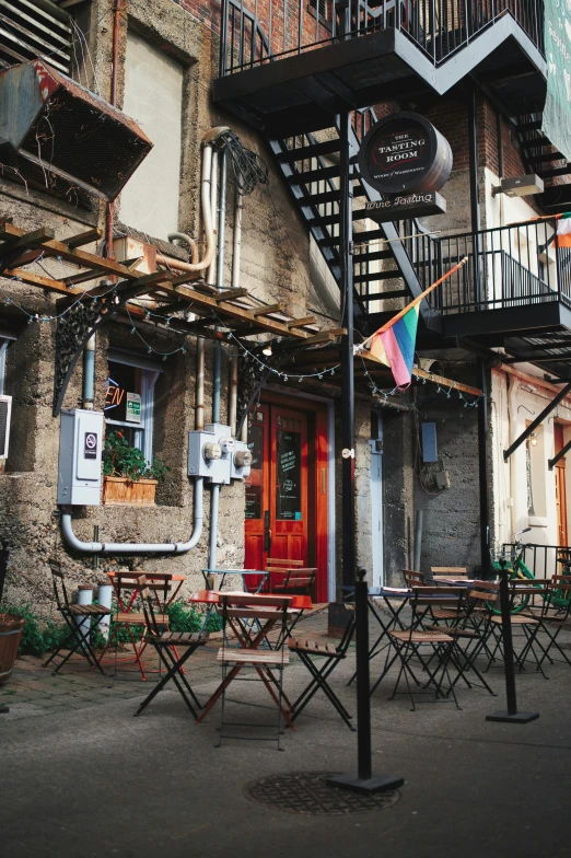 a set of three picnic tables outside a two story building