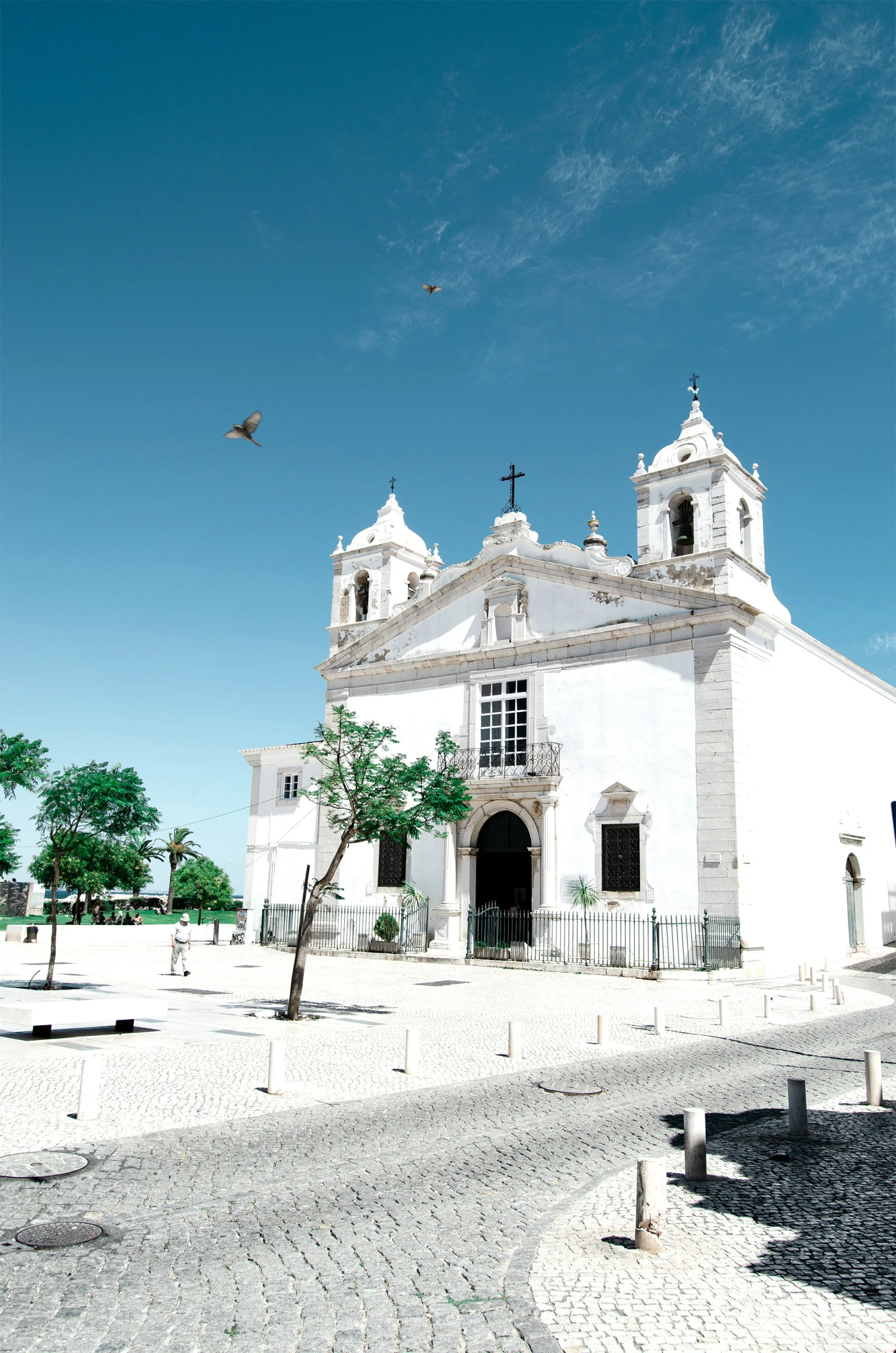 a white church with a tree on the side