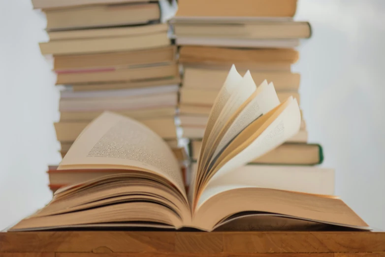 several stacked books on table, one large and one small