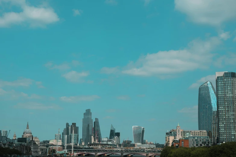 a blue sky in the city with tall buildings