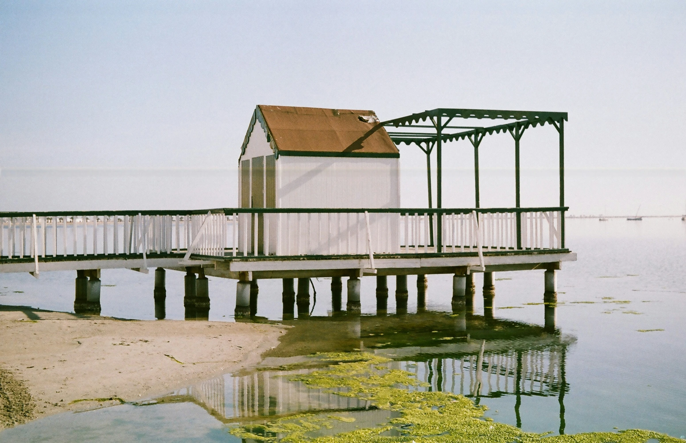 a pier with a boat house sitting on it