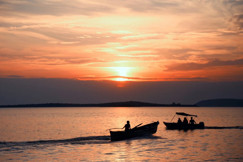 a couple of small boats traveling through a body of water