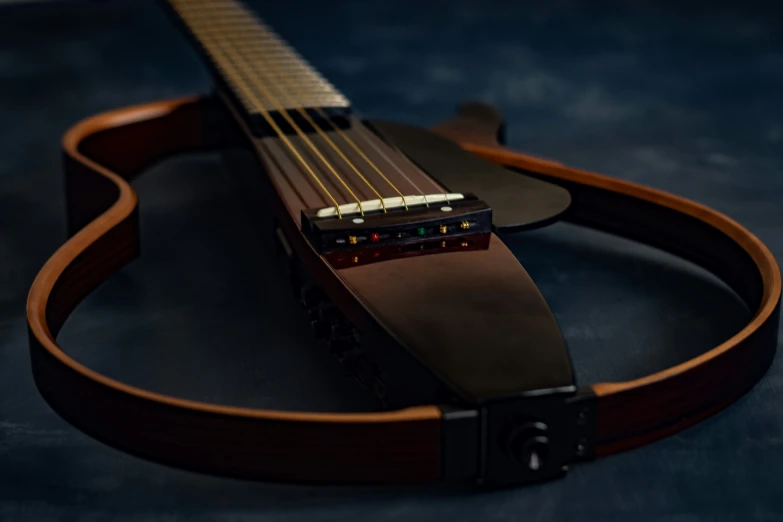 a guitar is lying on a surface and a strap