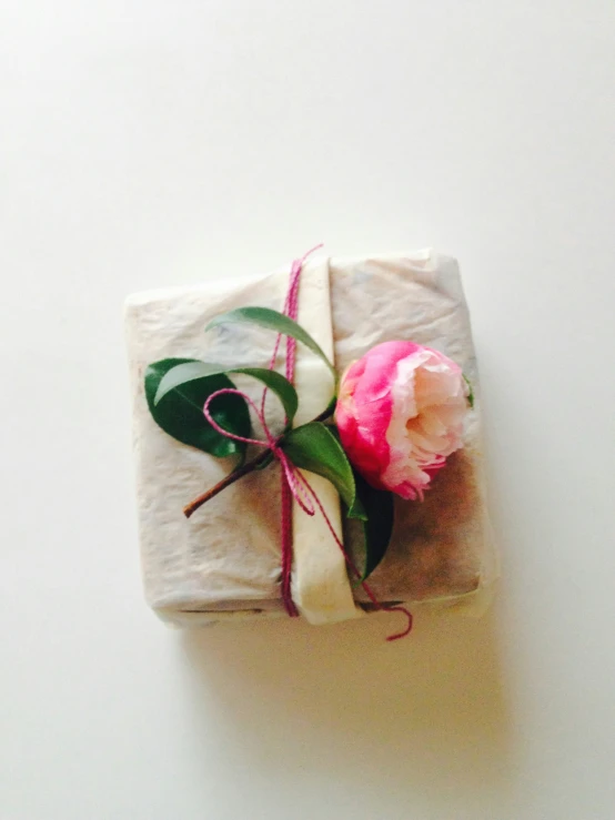 wrapped gift with a single flower and ribbon