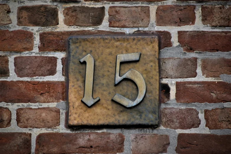 a number one is attached to a brick wall