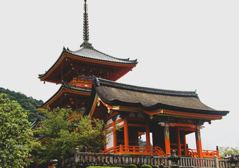 a building with red pillars in a park