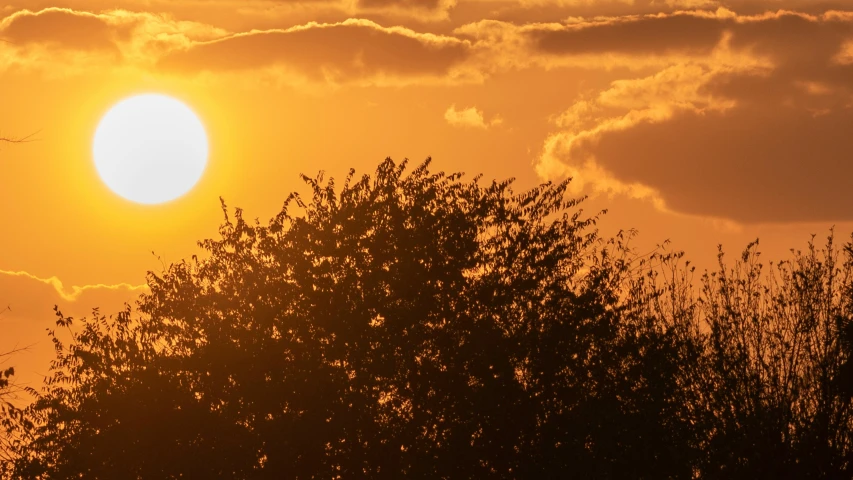 the sun is shining brightly in the horizon as it sets