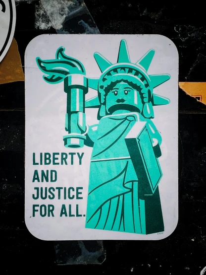 a green and white liberty and justice sticker