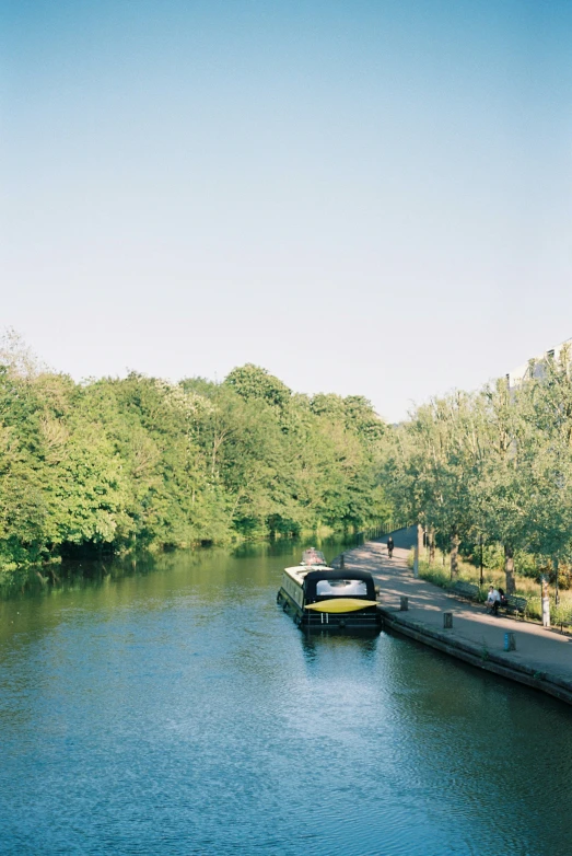 two boats are traveling on the water between the land