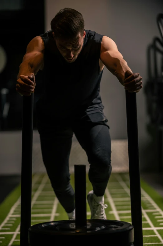 a man doing exercises on parallel bar with grass