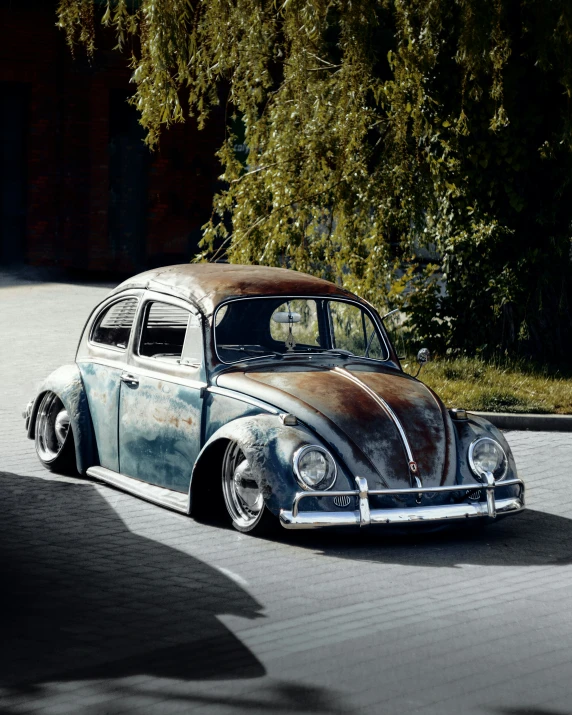 old dirty looking car parked in front of trees