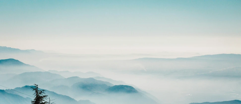 the view of some mountains from high above