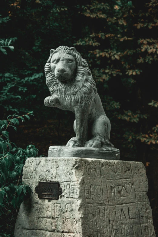 a lion statue sitting on top of a stone