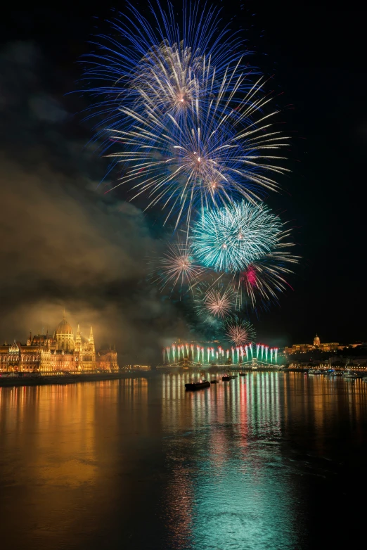 a nighttime sky s with fireworks above water