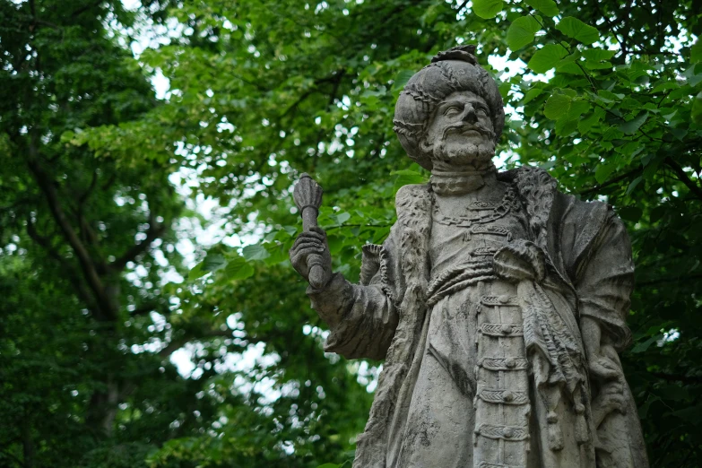 a statue with trees in the background
