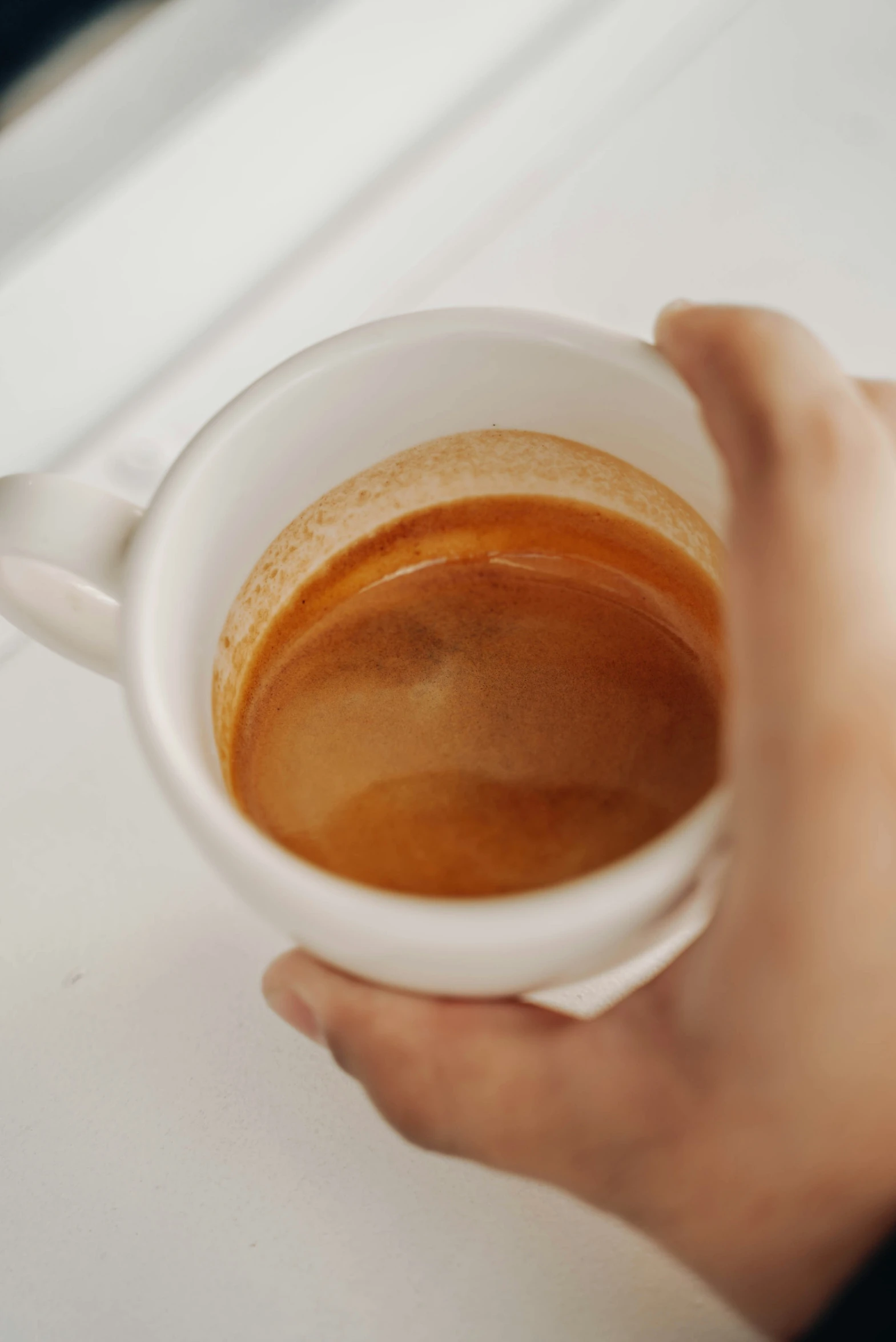 a persons hands hold a cup of coffee