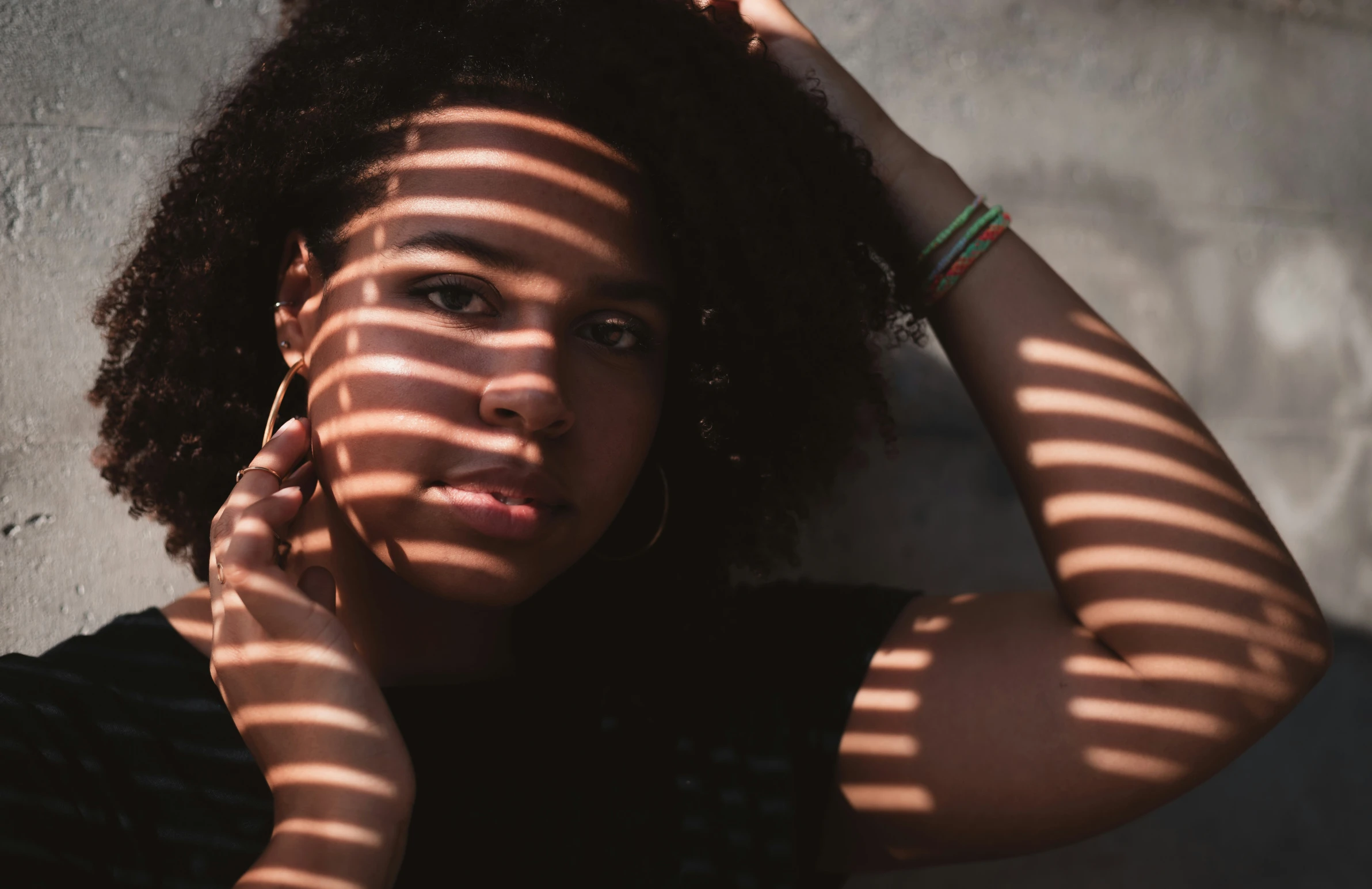 a woman holding her hair in front of her face