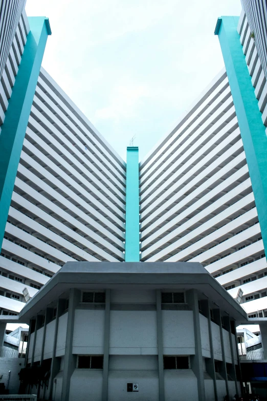 two tall buildings with very little sky in the background