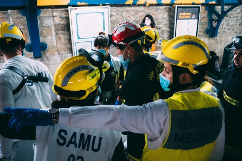 a group of firemen and civilians talking together