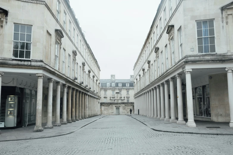 a paved courtyard with columns and a clock