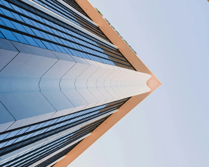 the view of a building with blue skies as seen from below