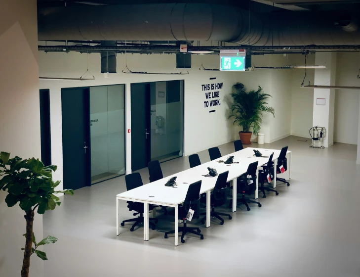 a conference room in the corner of an office with door open