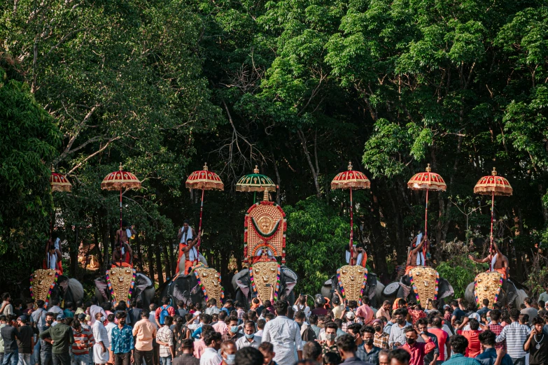 two giant elephants with headdress at an outdoor event