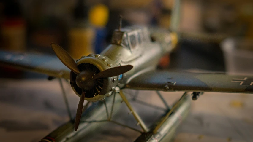 the old biplane is parked in a parking lot