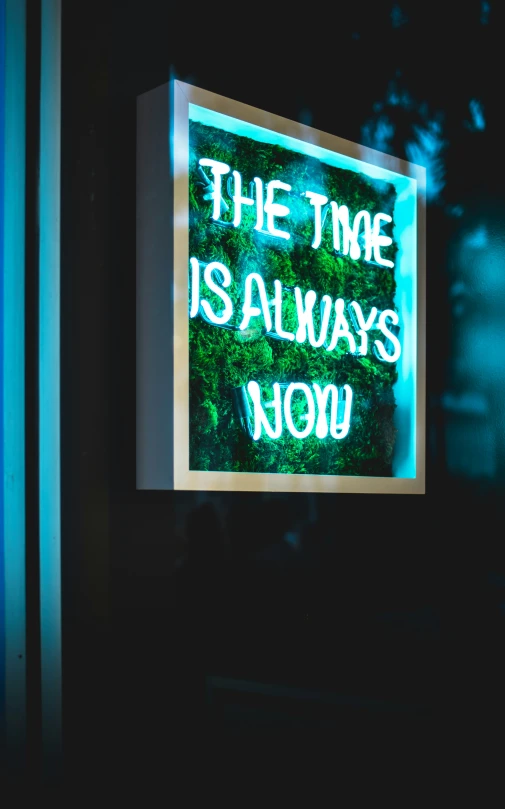 a neon sign hanging from the side of a building