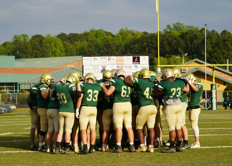 a team of people in green and white uniforms on the field