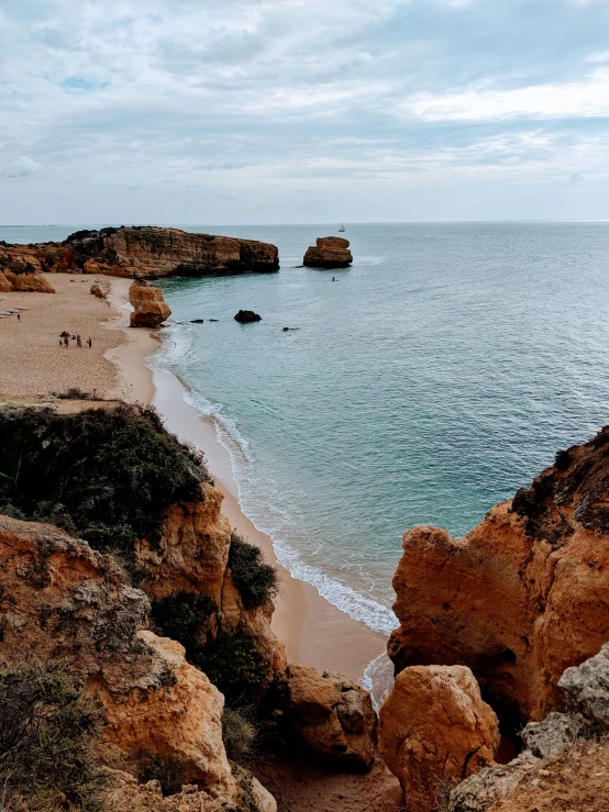 a beach with an ocean view and many rocks