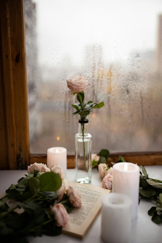 a view out of a window, a book and some candles