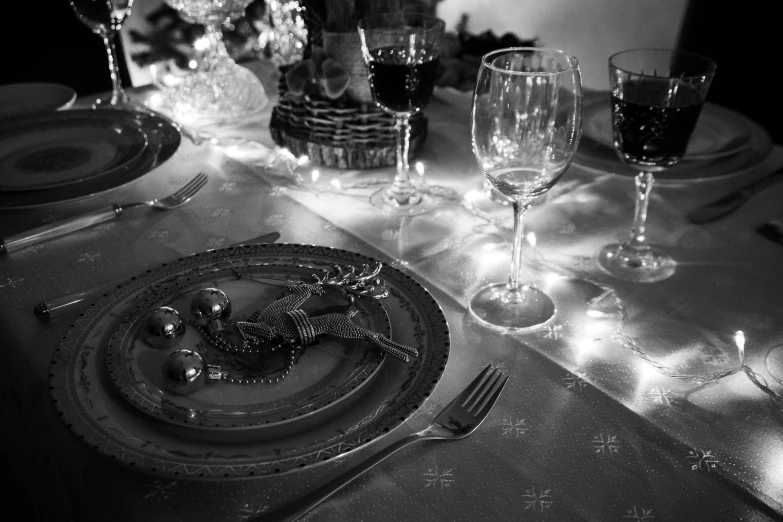 this is a formal table setting with candles and glasses