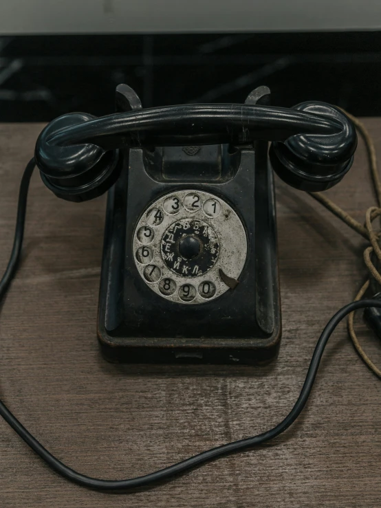 an old rotary phone sits on the floor