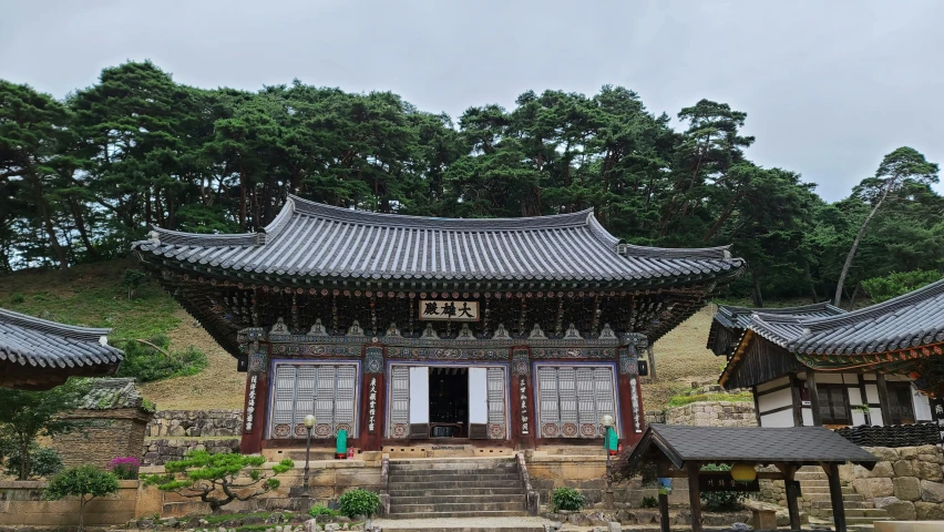 a large chinese style building with trees in the background