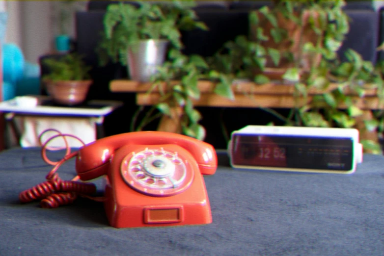 a small red phone on a blue table cloth