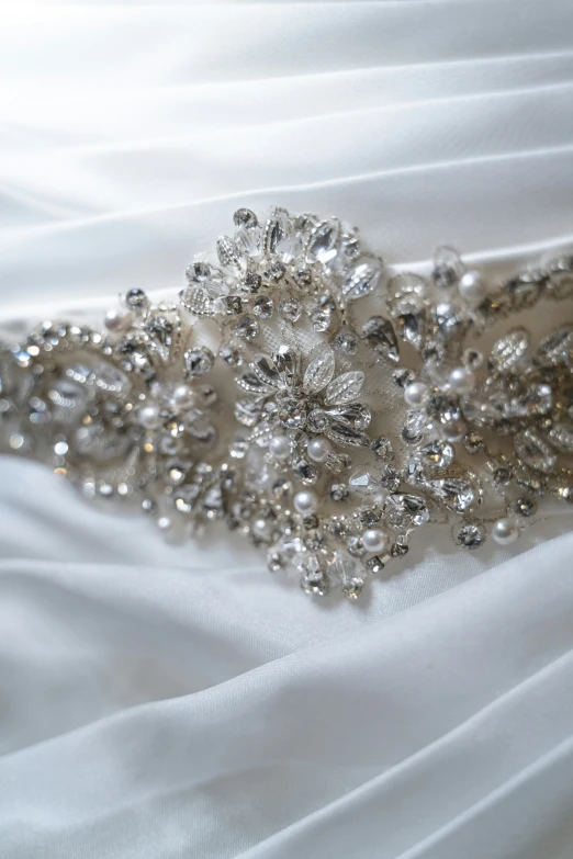 wedding sash with beaded flowers on a white fabric