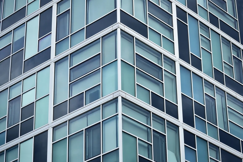 an upward view of glass panels on a building