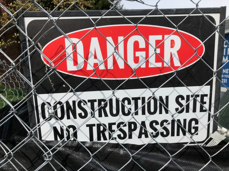 a sign is posted behind a fence in the country