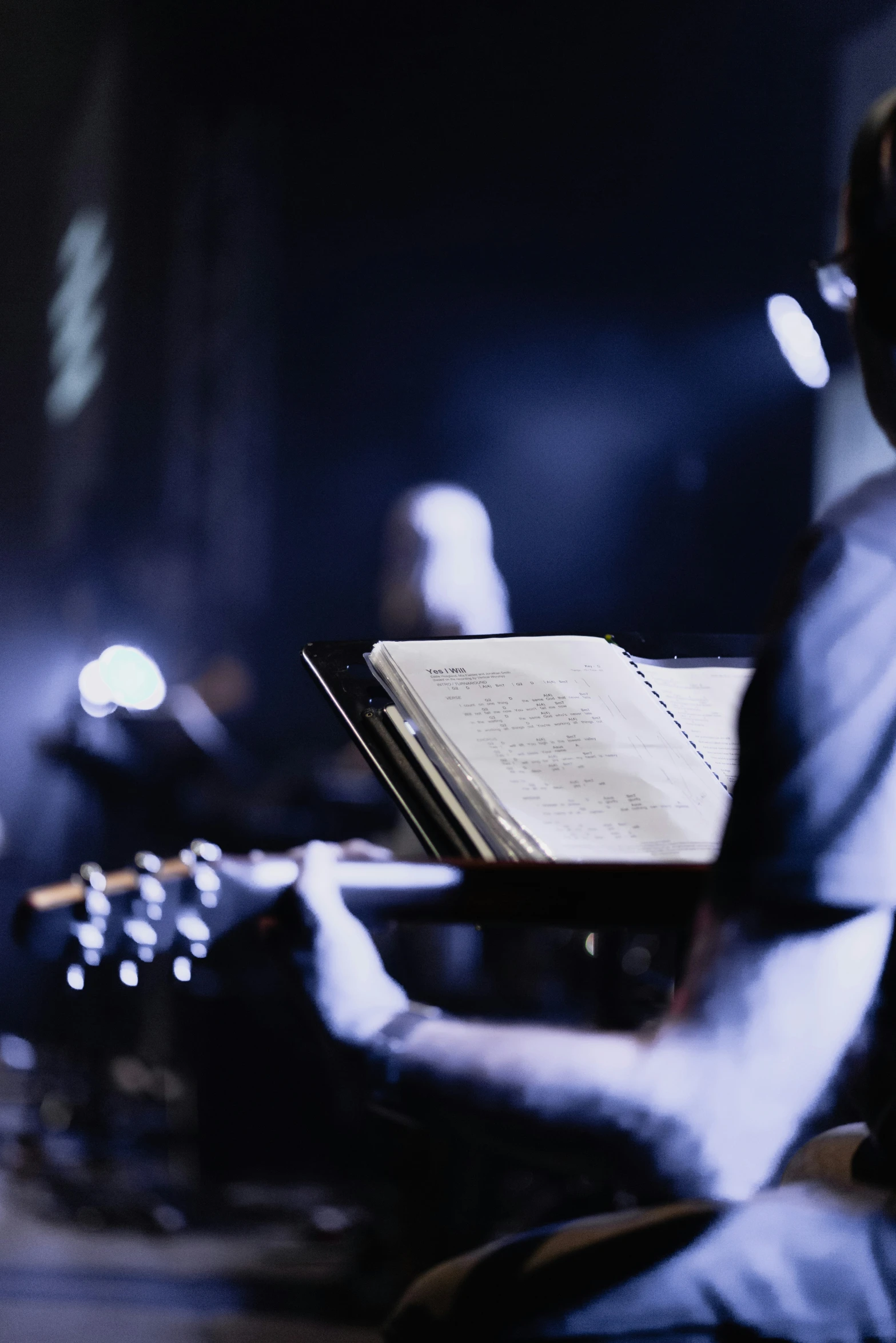 a musician is performing in a dimly lit studio