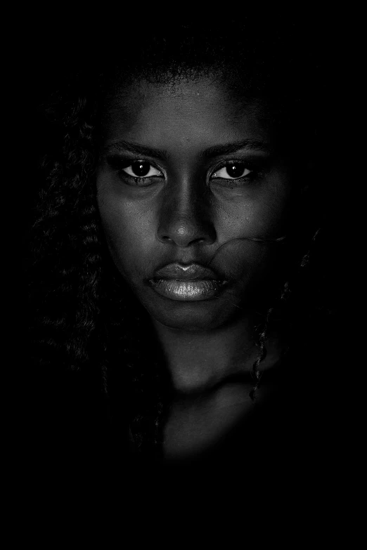 black and white image of a woman's face with dark background