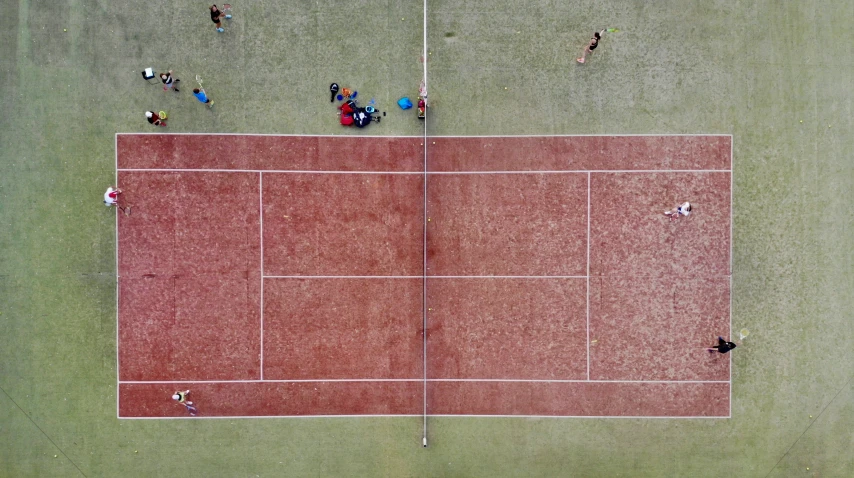 a group of people playing tennis on a court