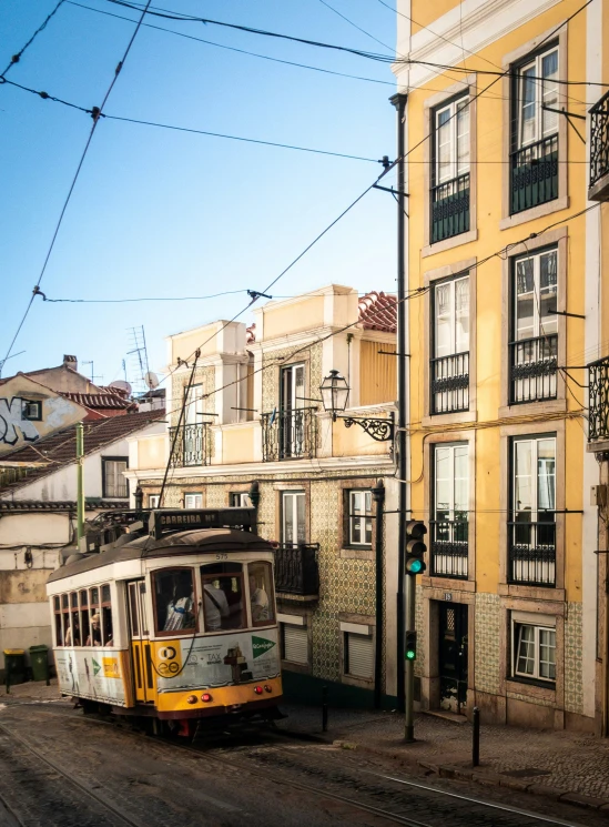 a trolley that is on the road and some buildings