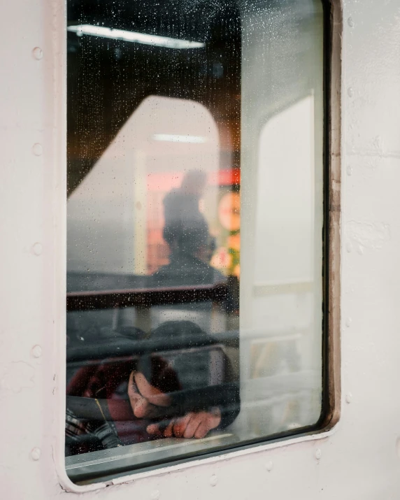 there are people looking out of the window on a train