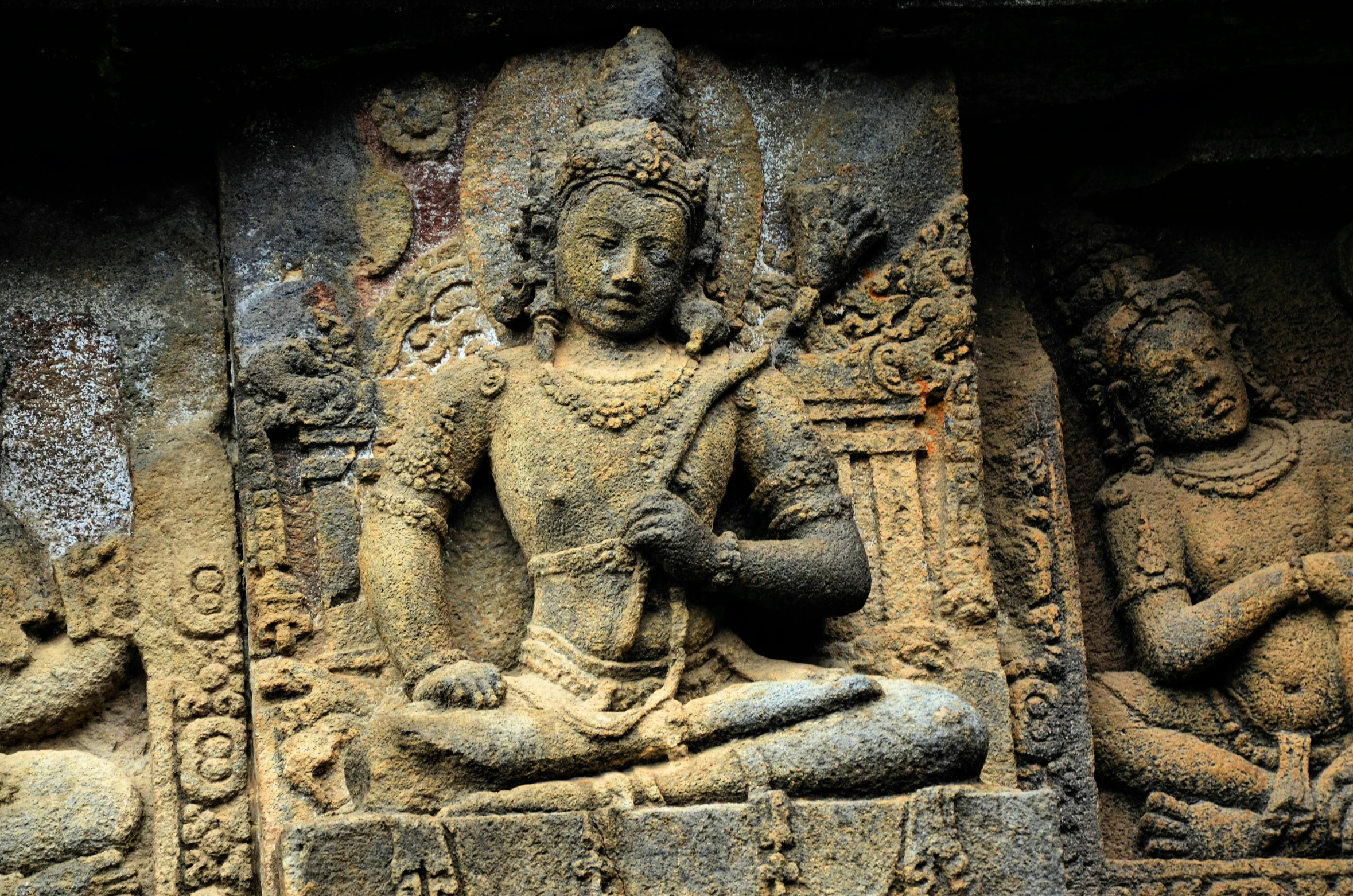 an ornately carved sculpture sits on display at the entrance to a building