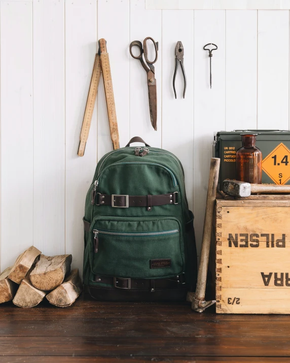 some tools are leaning against the wall behind some logs