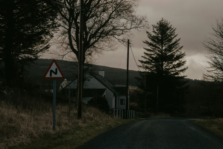 a road sign on the corner of a small road