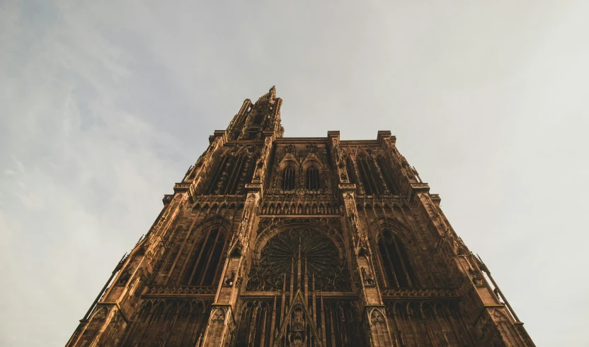 looking up at a large church steeple in the sunlight