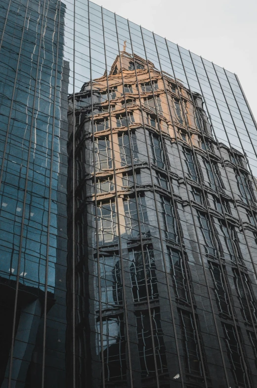 a large building reflecting off a building facade