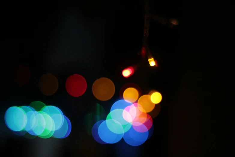 blurry pograph of several traffic lights with colored circles
